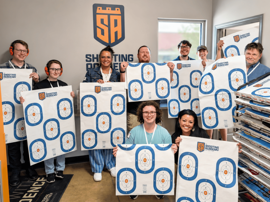 Group holding shooting targets indoors